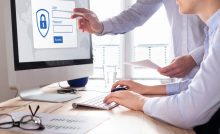 secure login on computer with two business people